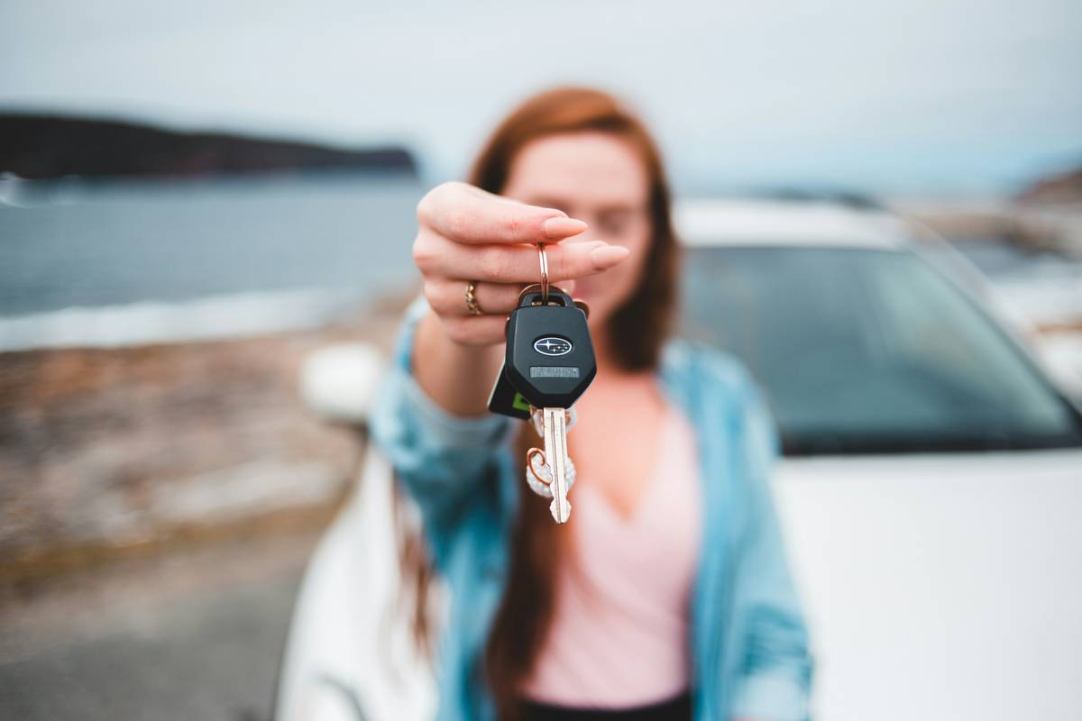 rental insurance benefit car how to: man reviewing credit card benefits at rental car counter